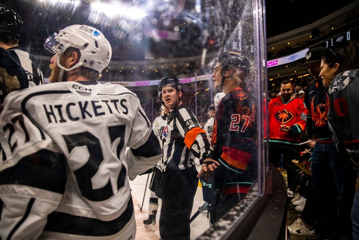A referee steps in between Ontario defenseman Joe Hicketts (27) and Coachella Valley forward Ryan Winterton (27) during the first period of Game 2 of the Pacific Division Finals at Acrisure Arena in Palm Desert, Calif., Friday, May 17, 2024.