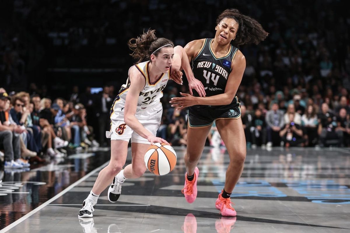 May 18, 2024; Brooklyn, New York, USA;  Indiana Fever guard Caitlin Clark (22) looks to drive past New York Liberty forward Betnijah Laney-Hamilton (44) in the first quarter at Barclays Center. Mandatory Credit: Wendell Cruz-USA TODAY Sports
