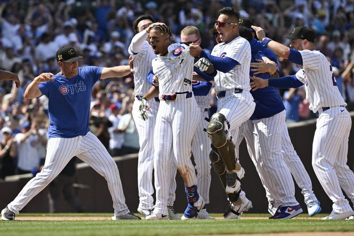 May 18, 2024; Chicago, Illinois, USA; Chicago Cubs Christopher Morel (5), center, celebrates with teammates after Morel hit a game winning RBI single against the Pittsburgh Pirates  at Wrigley Field. Mandatory Credit: Matt Marton-USA TODAY Sports