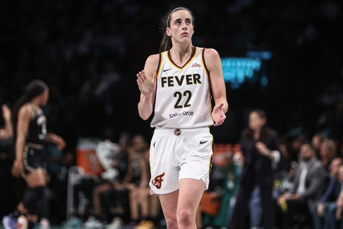 May 18, 2024; Brooklyn, New York, USA;  Indiana Fever guard Caitlin Clark (22) applauds while looking at the scoreboard in the third quarter against the New York Liberty at Barclays Center. Mandatory Credit: Wendell Cruz-USA TODAY Sports