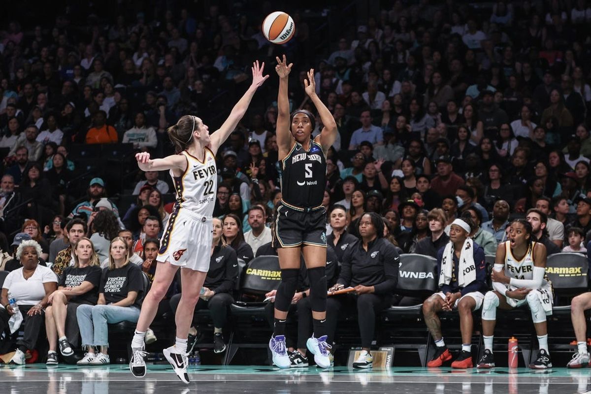 May 18, 2024; Brooklyn, New York, USA;  New York Liberty forward Kayla Thornton (5) takes a three point shot past Indiana Fever guard Caitlin Clark (22) in the fourth quarter at Barclays Center. Mandatory Credit: Wendell Cruz-USA TODAY Sports