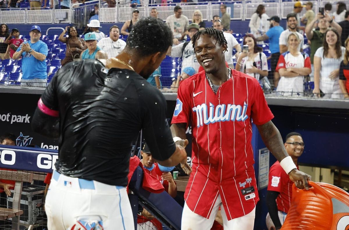 May 18, 2024; Miami, Florida, USA;  Miami Marlins third baseman Otto Lopez (61) and center fielder Jazz Chisholm Jr. (2) celebrate after Lopez had the game winning hit in extra innings against the New York Mets  at loanDepot Park. Mandatory Credit: Rhona Wise-USA TODAY Sports