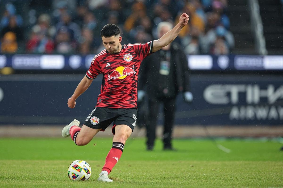May 18, 2024; Queens, New York, USA; New York Red Bulls midfielder Lewis Morgan (9) kicks the ball against New York City FC during the first half at Citi Field. Mandatory Credit: Vincent Carchietta-USA TODAY Sports