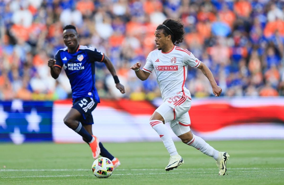 May 18, 2024; Cincinnati, Ohio, USA; St. Louis CITY SC midfielder Aziel Jackson (25) dribbles the ball against FC Cincinnati midfielder Obinna Nwobodo (5) during the first half at TQL Stadium. Mandatory Credit: Katie Stratman-USA TODAY Sports