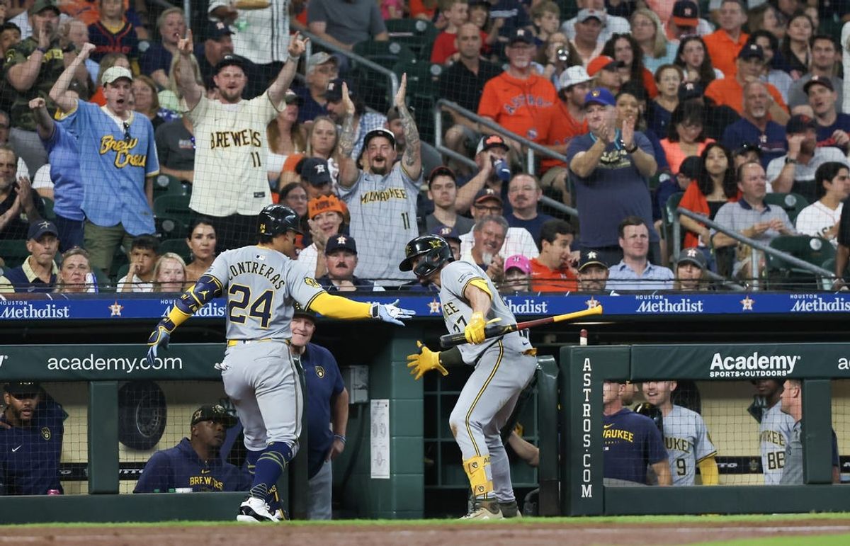 May 18, 2024; Houston, Texas, USA; Milwaukee Brewers shortstop Willy Adames (27) celebrates catcher William Contreras (24) three-run home run against the Houston Astros in the fifth inning at Minute Maid Park. Mandatory Credit: Thomas Shea-USA TODAY Sports