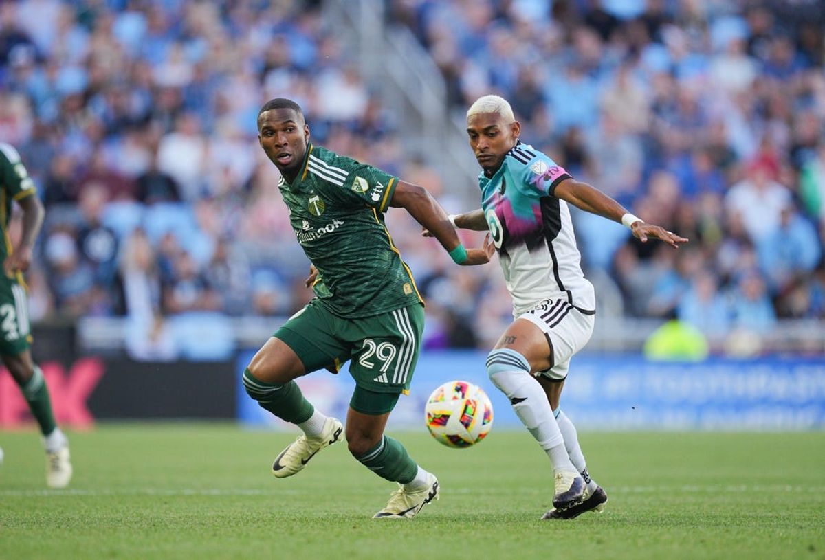 May 18, 2024; Saint Paul, Minnesota, USA; Portland Timbers defender Juan Mosquera (29) battles for the ball against Minnesota United forward Joseph Rosales (8) during the first half at Allianz Field. Mandatory Credit: Brad Rempel-USA TODAY Sports