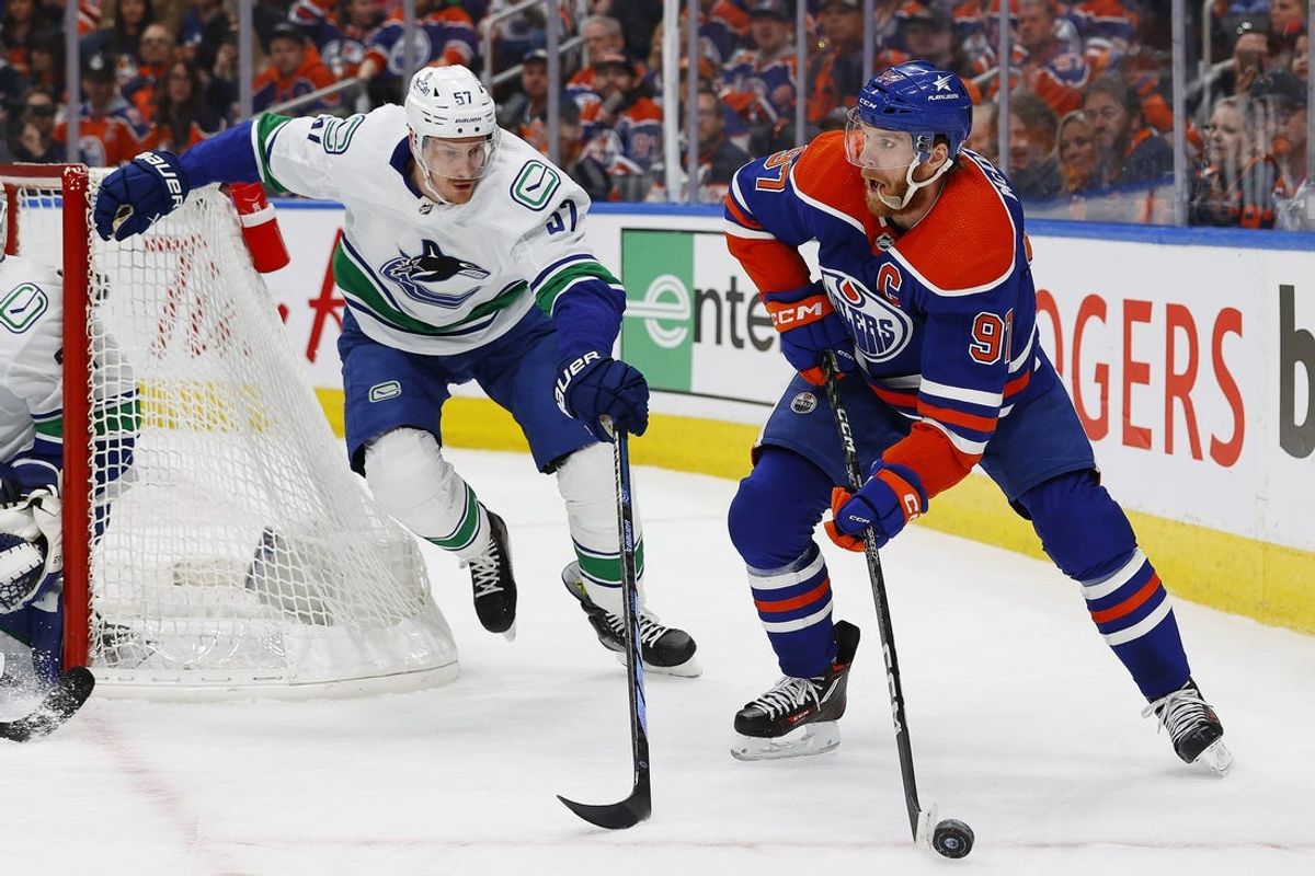 May 18, 2024; Edmonton, Alberta, CAN; Edmonton Oilers forward Connor McDavid (97) looks to make a pass in front of Vancouver Canucks defensemen Tyler Myers (57) during the first period in game six of the second round of the 2024 Stanley Cup Playoffs at Rogers Place. Mandatory Credit: Perry Nelson-USA TODAY Sports