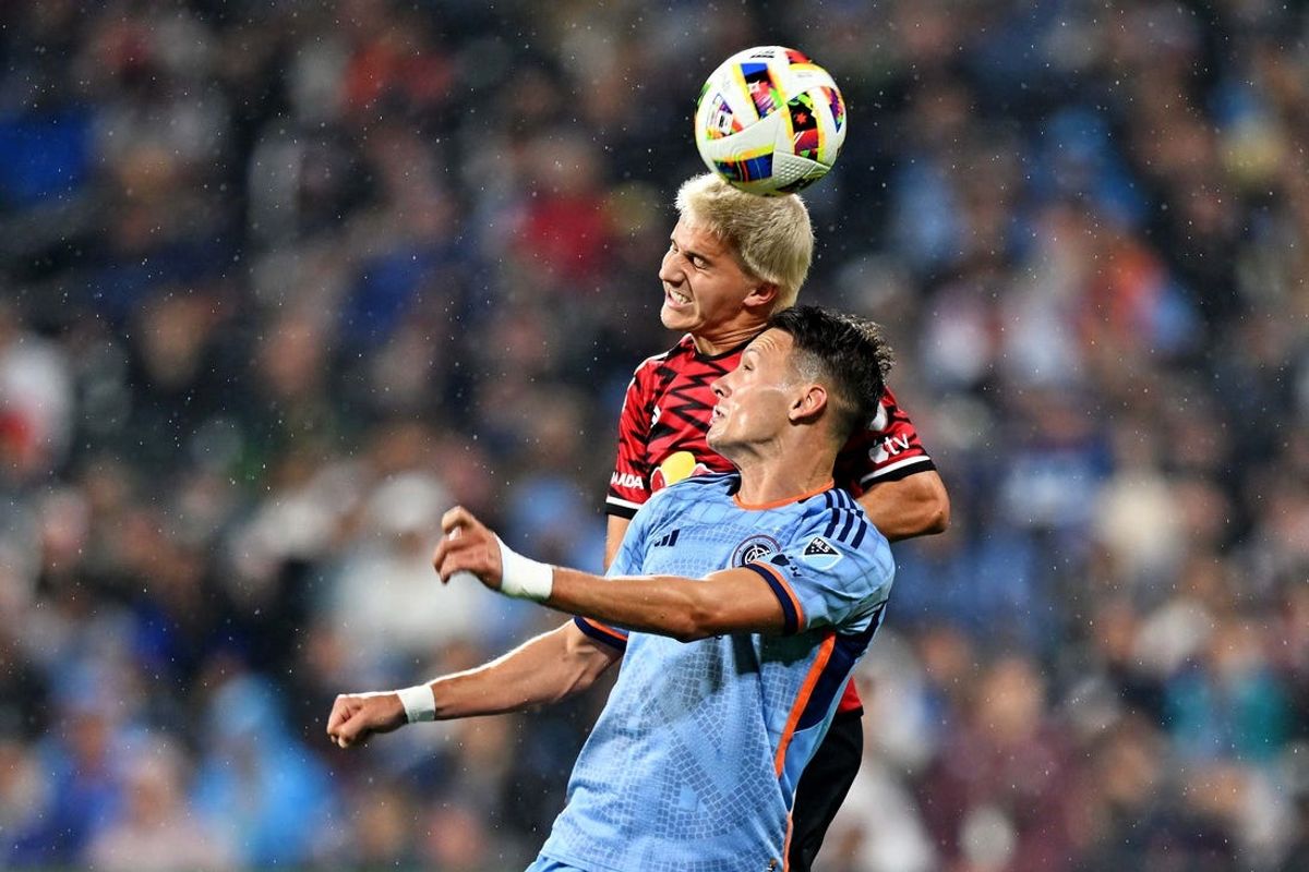 May 18, 2024; New York, New York, USA; New York Red Bulls defender John Tolkin (47) and New York City FC forward Hannes Wolff (17) go for the ball during the second half at Citi Field. Mandatory Credit: Mark Smith-USA TODAY Sports