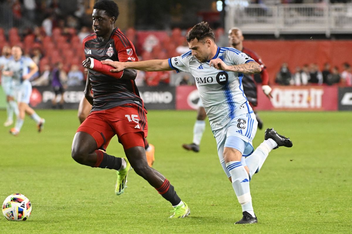 May 18, 2024; Toronto, Ontario, CAN; Toronto FC forward Nicksoen Gomis (15) plays the ball defended by CF Montreal midfielder Dominik Yankov (8) in the second half at BMO Field. Mandatory Credit: Gerry Angus-USA TODAY Sports