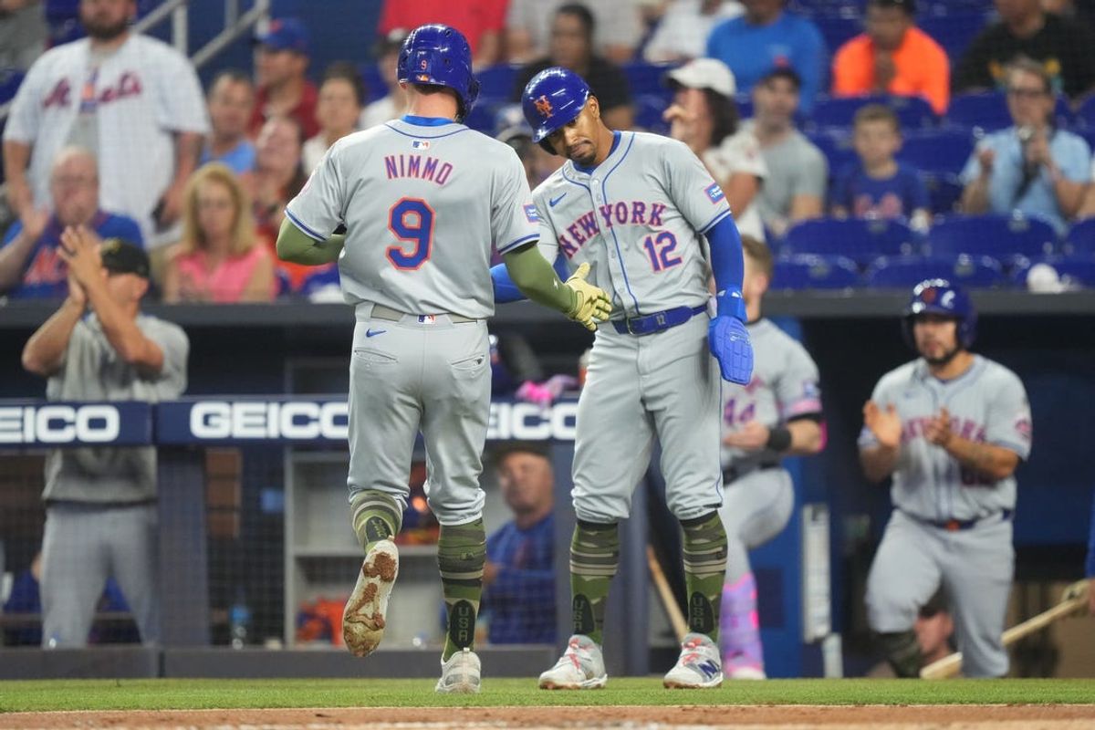 May 19, 2024; Miami, Florida, USA;  New York Mets shortstop Francisco Lindor (12) congratulates designated hitter Brandon Nimmo (9) after they both scored in the first inning against the Miami Marlins at loanDepot Park. Mandatory Credit: Jim Rassol-USA TODAY Sports