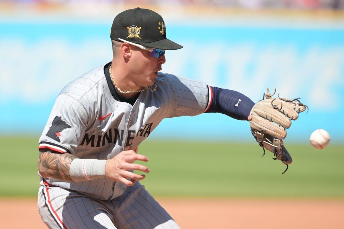 May 19, 2024; Cleveland, Ohio, USA; Minnesota Twins third baseman Jose Miranda (64) fields a ball hit by  Cleveland Guardians center fielder Tyler Freeman (2) during the ninth inning at Progressive Field. Mandatory Credit: Ken Blaze-USA TODAY Sports