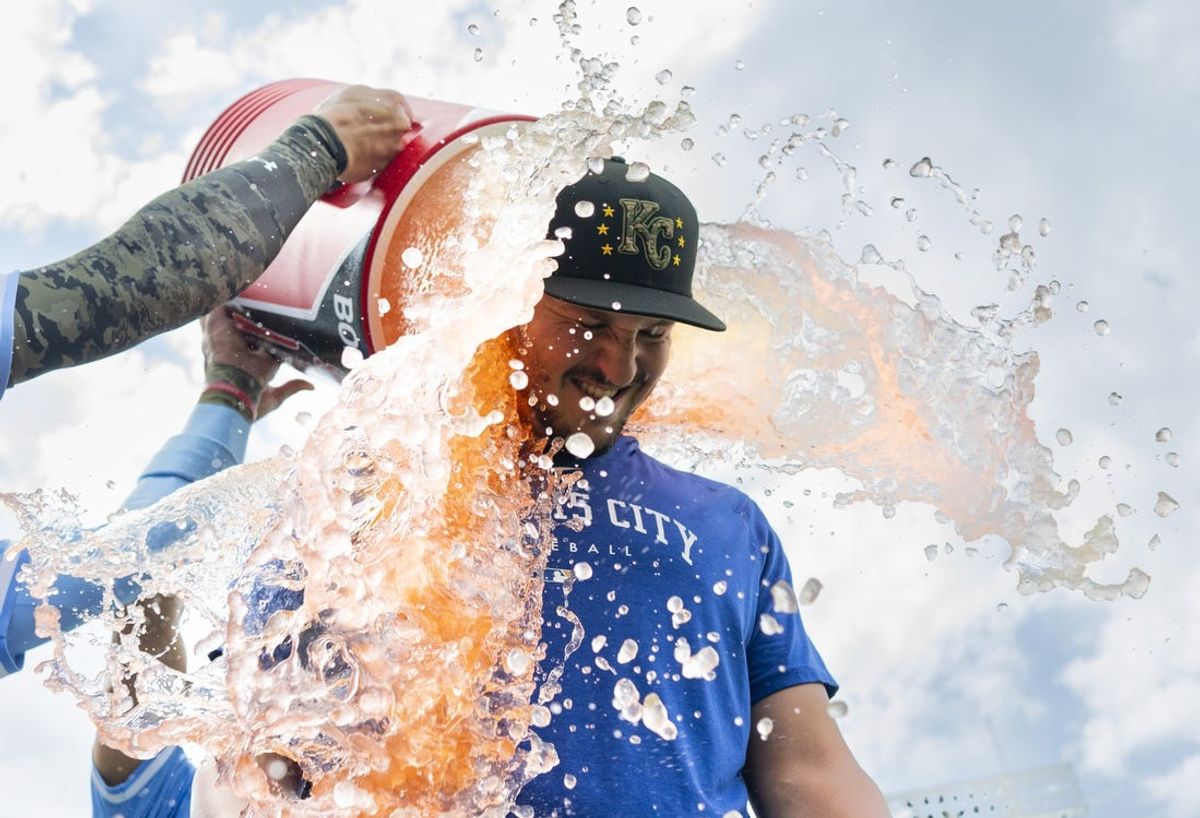 May 19, 2024; Kansas City, Missouri, USA; Kansas City Royals first baseman Vinnie Pasquantino (9) is doused by left fielder MJ Melendez (1) and shortstop Bobby Witt Jr. (7) after defeating the Oakland Athletics at Kauffman Stadium. Mandatory Credit: Jay Biggerstaff-USA TODAY Sports