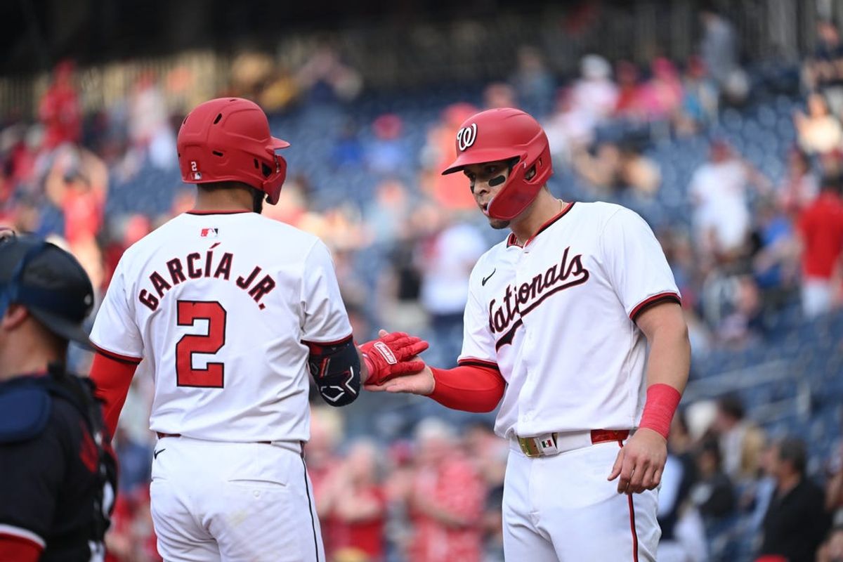 May 20, 2024; Washington, District of Columbia, USA; Washington Nationals first baseman Joey Meneses (45) celebrates a home run by second baseman Luis García Jr. (2) at home plate during the second inning at Nationals Park. Mandatory Credit: Rafael Suanes-USA TODAY Sports