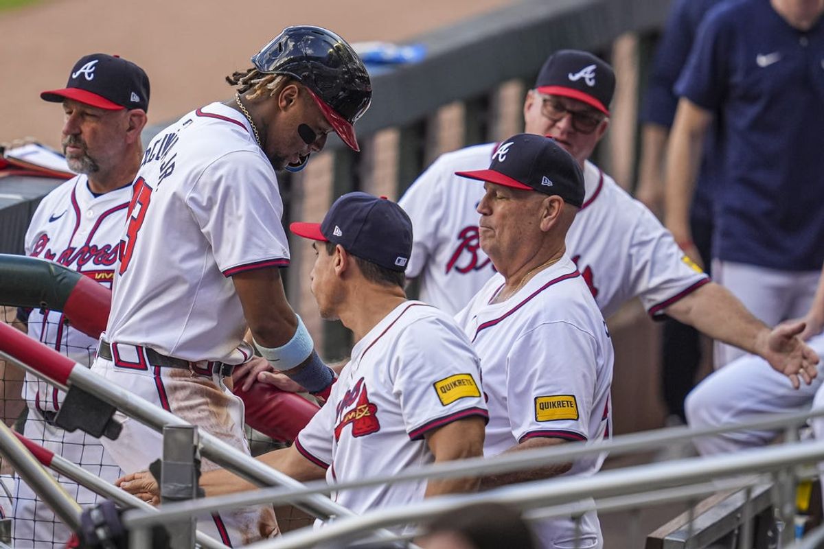 May 20, 2024; Cumberland, Georgia, USA; Atlanta Braves right fielder Ronald Acuna Jr (13) is greeted in the dugout after scoring a run against the San Diego Padres during the first inning at Truist Park. Mandatory Credit: Dale Zanine-USA TODAY Sports