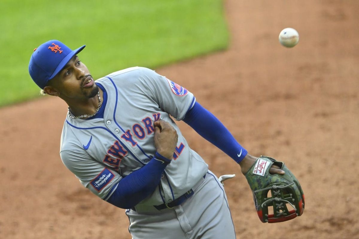 May 20, 2024; Cleveland, Ohio, USA; New York Mets shortstop Francisco Lindor (12) tosses a ball to the stands in the fourth inning against the Cleveland Guardians at Progressive Field. Mandatory Credit: David Richard-USA TODAY Sports
