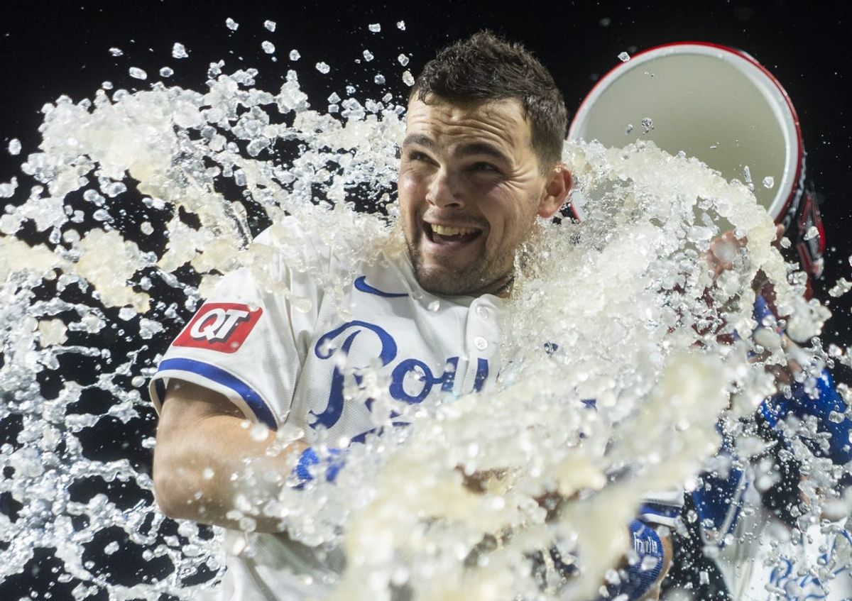 May 20, 2024; Kansas City, Missouri, USA; Kansas City Royals second baseman Michael Massey (19) is doused by shortstop Bobby Witt Jr. (7) after defeating the Detroit Tigers at Kauffman Stadium. Mandatory Credit: Jay Biggerstaff-USA TODAY Sports