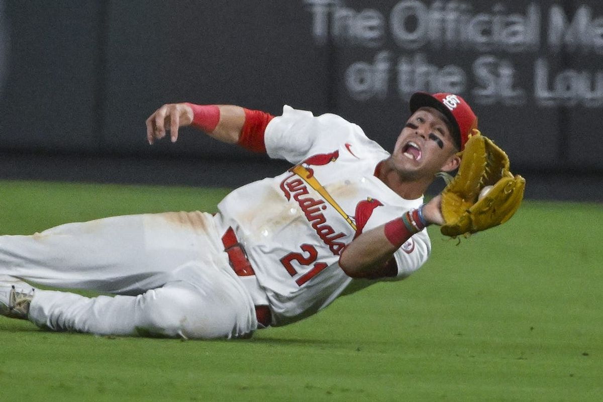 May 20, 2024; St. Louis, Missouri, USA;  St. Louis Cardinals right fielder Lars Nootbaar (21) slides and catches a fly ball against the Baltimore Orioles during the eighth inning at Busch Stadium. Mandatory Credit: Jeff Curry-USA TODAY Sports