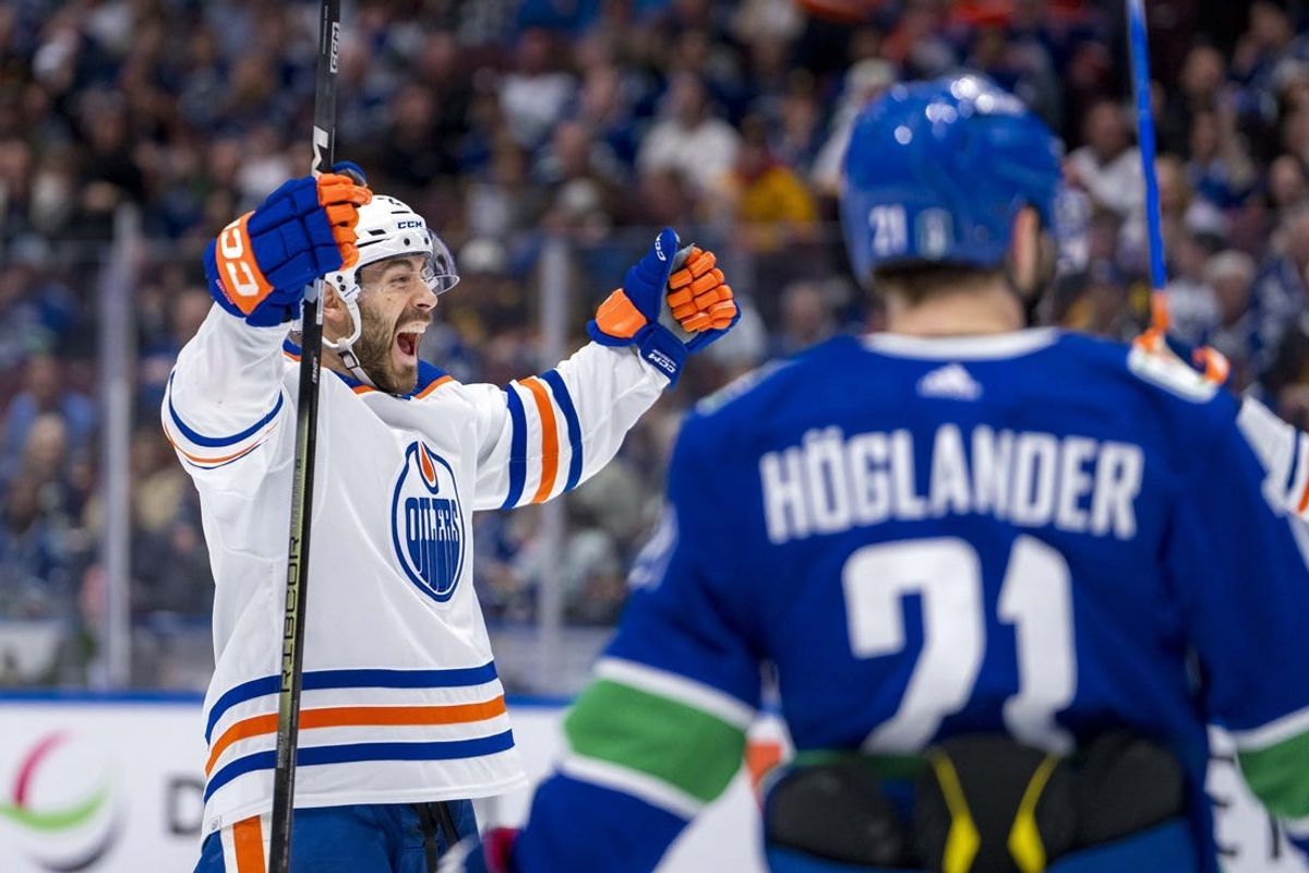 May 20, 2024; Vancouver, British Columbia, CAN; Vancouver Canucks forward Nils Hoglander (21) watches as Edmonton Oilers defenseman Evan Bouchard (2) celebrates his goal during the second period in game seven of the second round of the 2024 Stanley Cup Playoffs at Rogers Arena. Mandatory Credit: Bob Frid-USA TODAY Sports