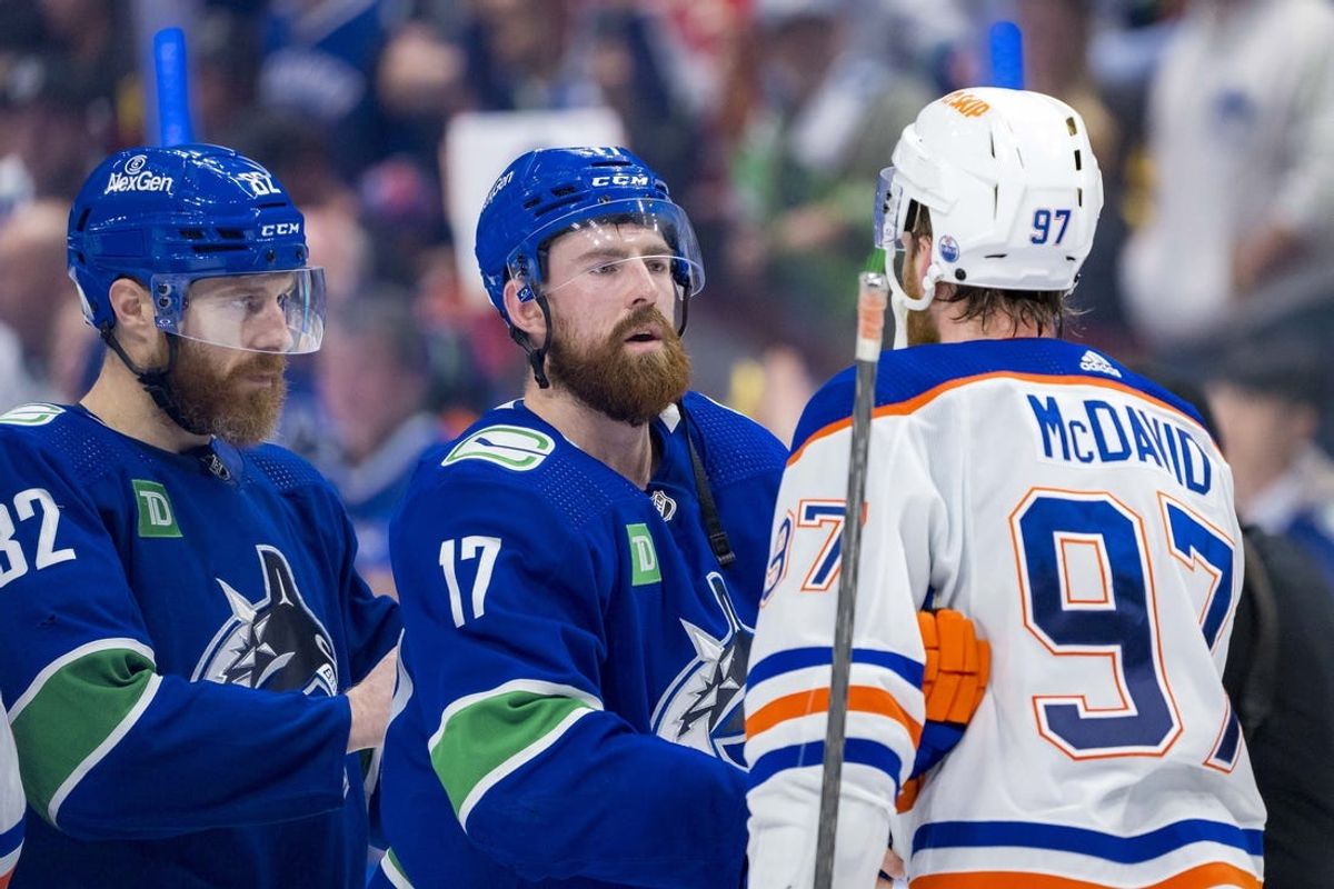 May 20, 2024; Vancouver, British Columbia, CAN; Vancouver Canucks defenseman Ian Cole (82) and defenseman Filip Hronek (17) shake hands with Edmonton Oilers forward Connor McDavid (97) after the Edmonton victory in game seven of the second round of the 2024 Stanley Cup Playoffs at Rogers Arena. Mandatory Credit: Bob Frid-USA TODAY Sports