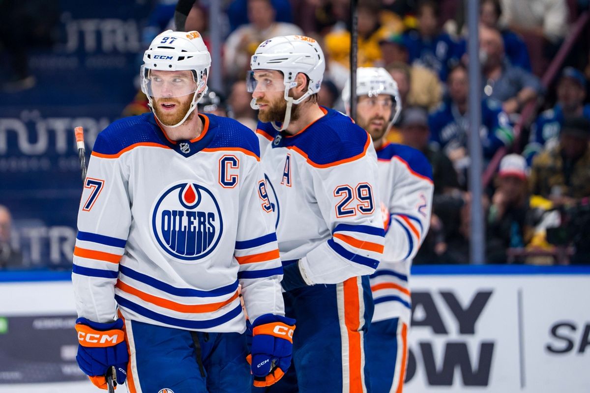 May 16, 2024; Vancouver, British Columbia, CAN; Edmonton Oilers forward Connor McDavid (97) and forward Leon Draisaitl (29) and defenseman Evan Bouchard (2) during a stop in play against the Vancouver Canucks during the first period in game five of the second round of the 2024 Stanley Cup Playoffs at Rogers Arena. Mandatory Credit: Bob Frid-Imagn Images