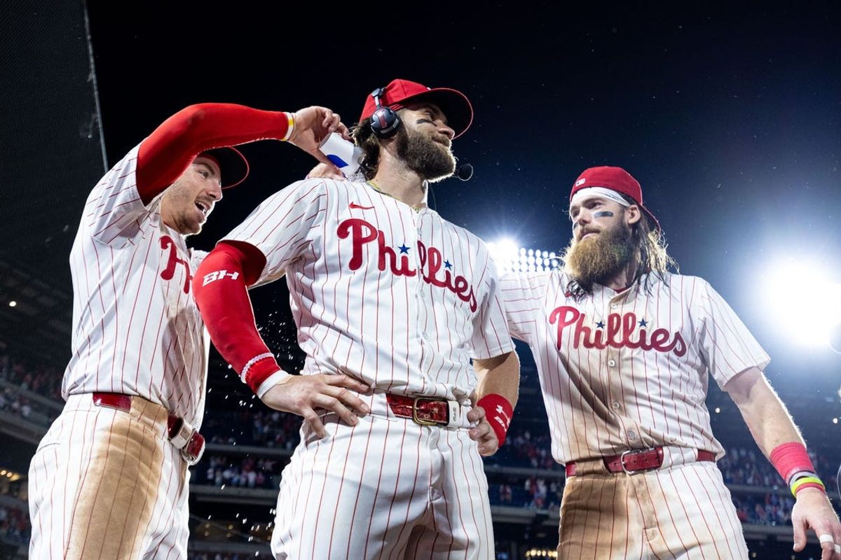 May 21, 2024; Philadelphia, Pennsylvania, USA; Philadelphia Phillies first base Bryce Harper (3) celebrates with Bryson Stott (L) and Brandon Marsh (R) after a victory against the Texas Rangers at Citizens Bank Park. Mandatory Credit: Bill Streicher-USA TODAY Sports