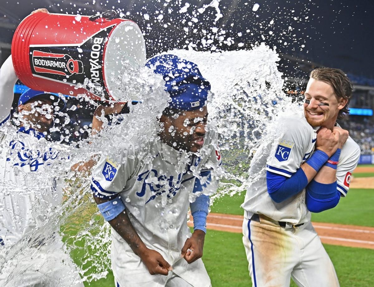 May 21, 2024; Kansas City, Missouri, USA;  Kansas City Royals third baseman Maikel Garcia (center) and shortstop Bobby Witt Jr. (right) receive a victory shower by teammate MJ Melendez (left) after beating the Detroit Tigers at Kauffman Stadium. Mandatory Credit: Peter Aiken-USA TODAY Sports