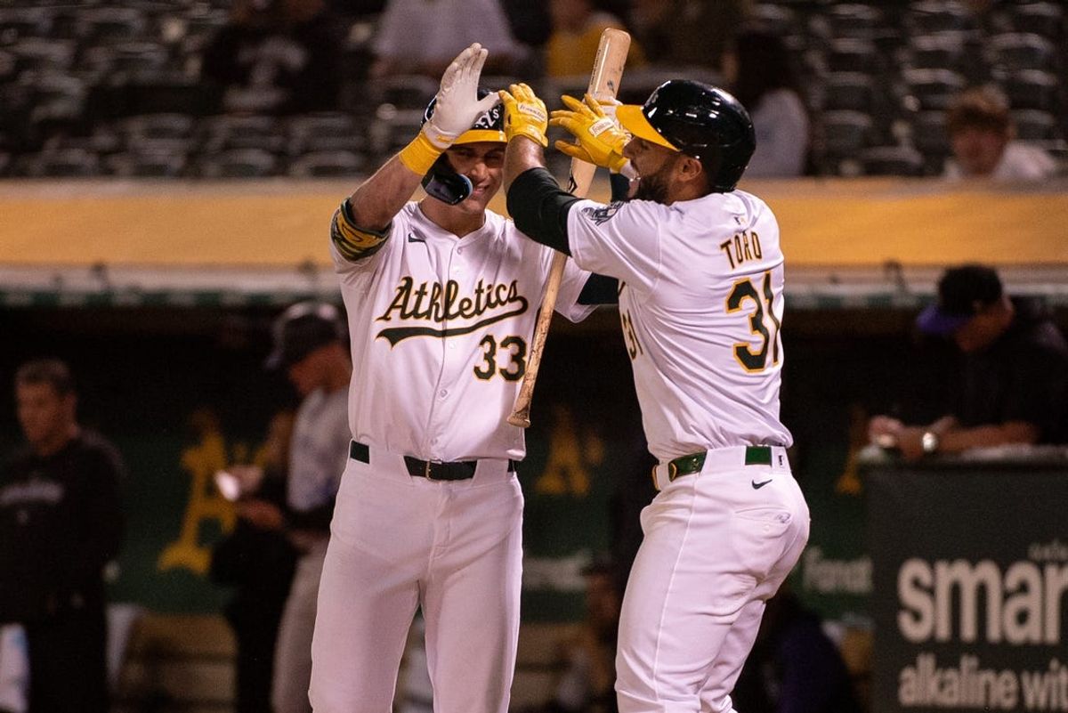 May 21, 2024; Oakland, California, USA; Oakland Athletics second base Abraham Toro (31) celebrates with outfielder JJ Bleday (33) after hitting a home run against the Colorado Rockies during the eighth inning at Oakland-Alameda County Coliseum. Mandatory Credit: Ed Szczepanski-USA TODAY Sports