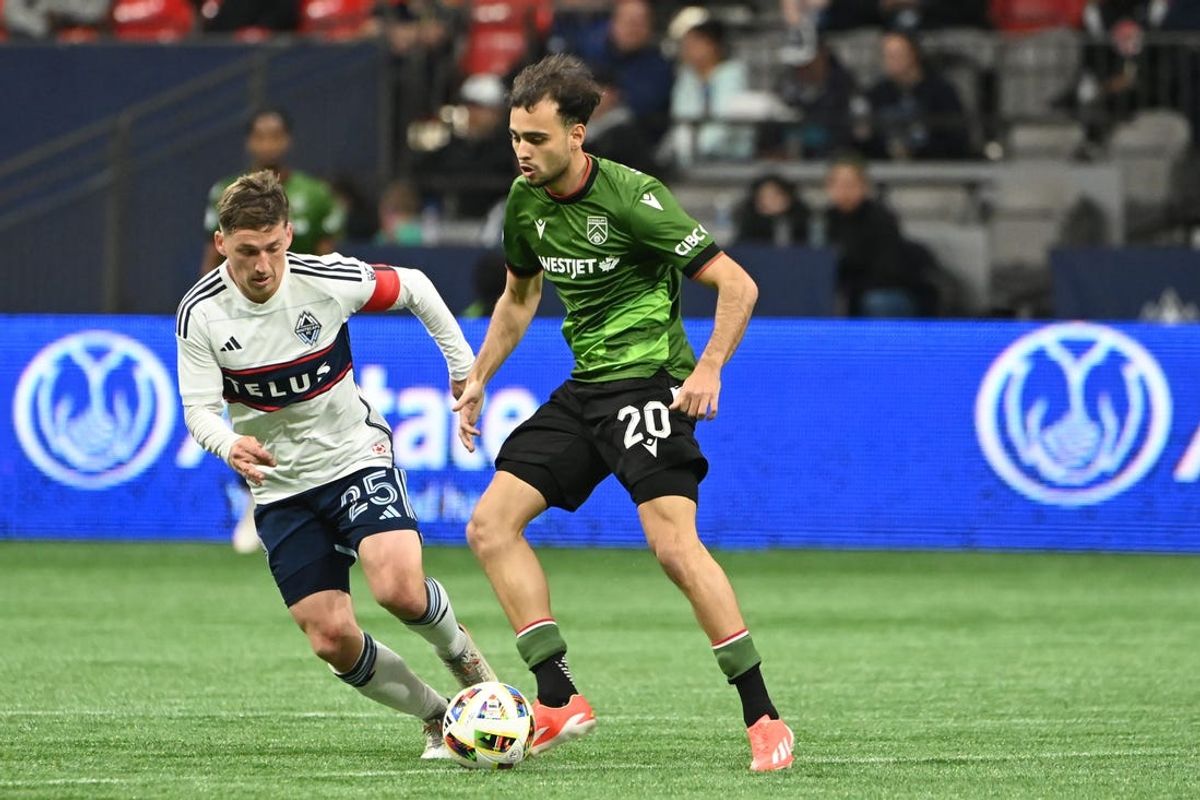May 21, 2024; Vancouver, British Columbia, CAN;  Vancouver Whitecaps FC midfielder Ryan Gauld (25) challenges Cavalry FC midfielder Lucas Dias (20) during the second half at BC Place. Mandatory Credit: Simon Fearn-USA TODAY Sports