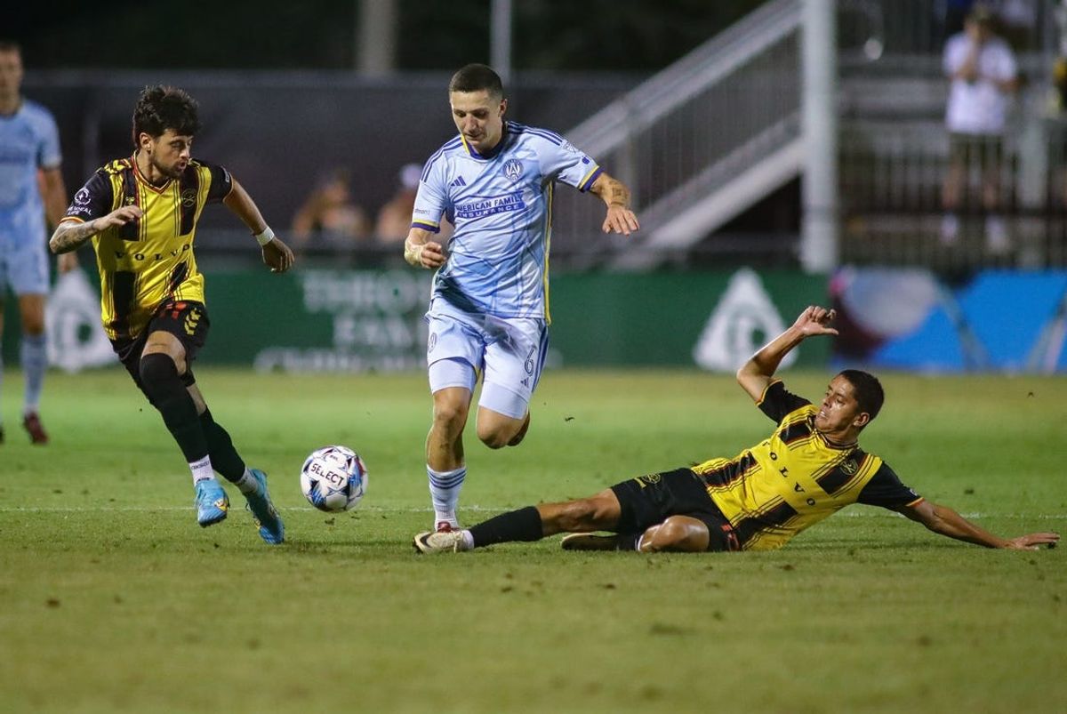 May 21, 2024; Mount Pleasant, South Carolina, USA; Atlanta United midfielder Bartosz Slisz (6) chases the ball against Charleston Battery forward Diego Gutierrez (11) and midfielder Arturo Rodriguez (10) during a US Open Cup round of 16 match at Patriot's Point Soccer Stadium. Mandatory Credit: Bernie Walls-USA TODAY Sports