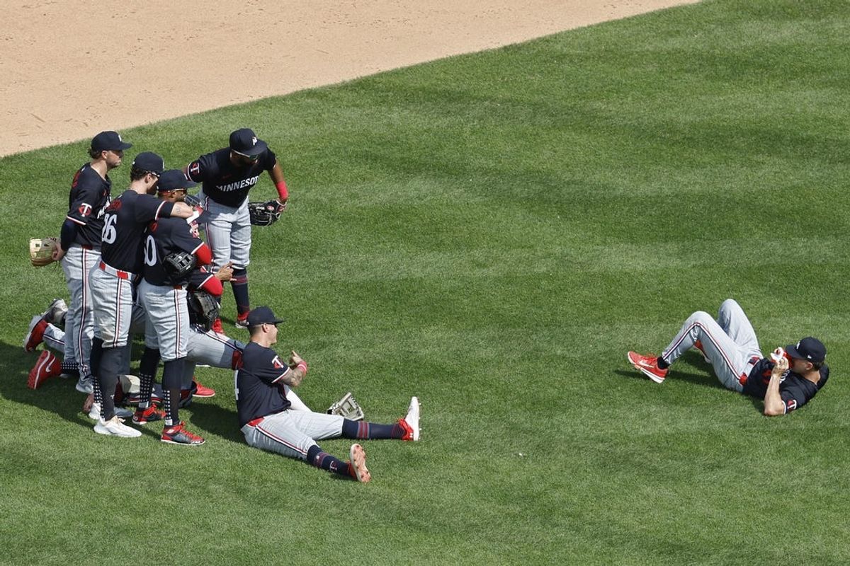 May 22, 2024; Washington, District of Columbia, USA; Minnesota Twins second base Edouard Julien (47) takes a Polaroid picture of teammates after their game against the Washington Nationals at Nationals Park. Mandatory Credit: Geoff Burke-USA TODAY Sports