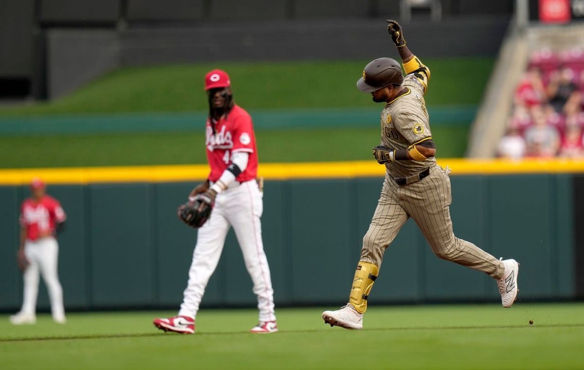 San Diego Padres Luis Arraez (4) runs past Cincinnati Reds third baseman Elly De La Cruz (44) in the1st inning after hitting a homer 374 feet Wednesday, May 22, 2024 at Great American Ball Park in Cincinnati.