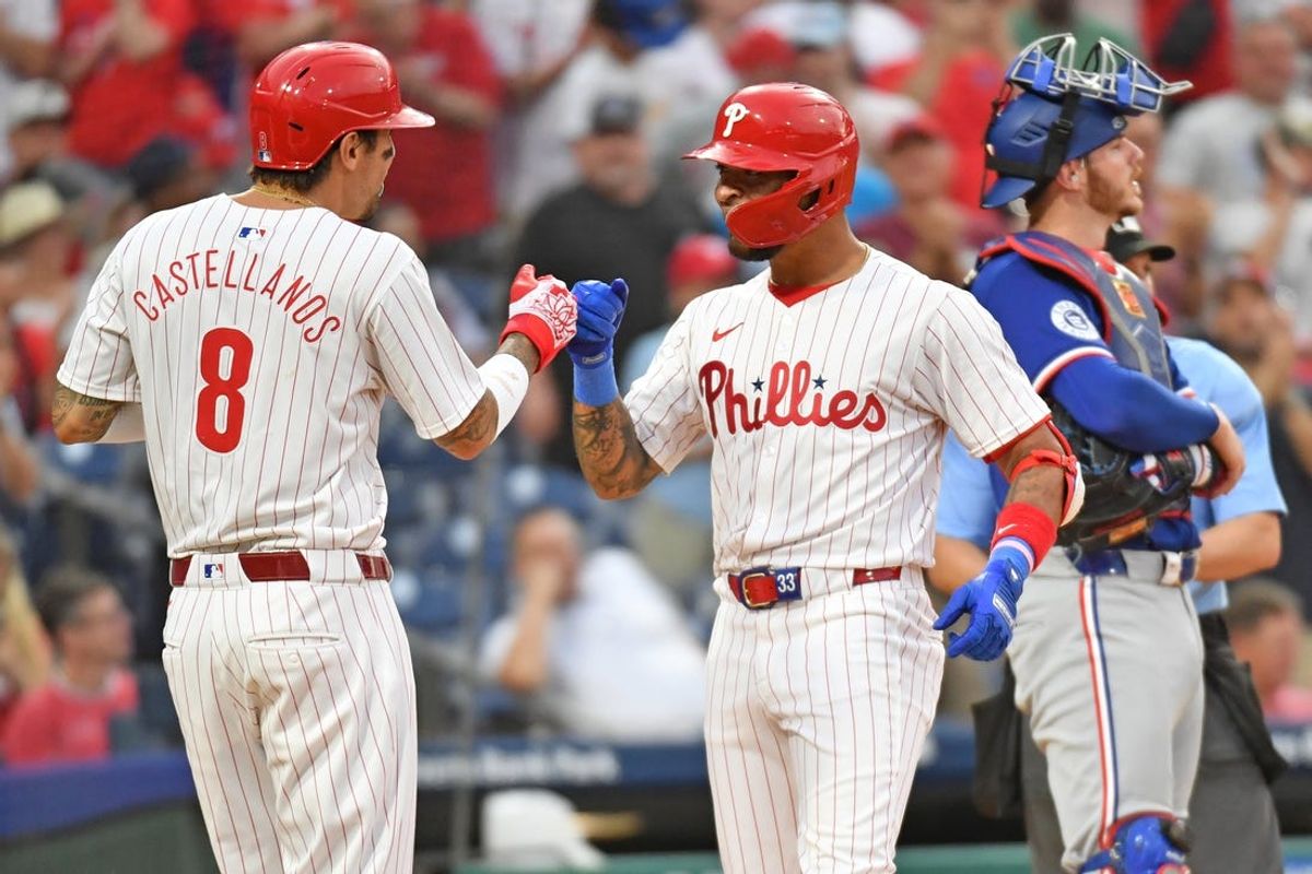 May 22, 2024; Philadelphia, Pennsylvania, USA; Philadelphia Phillies shortstop Edmundo Sosa (33) celebrates his home run with outfielder Nick Castellanos (8) against the Texas Rangers during the fourth inning at Citizens Bank Park. Mandatory Credit: Eric Hartline-USA TODAY Sports