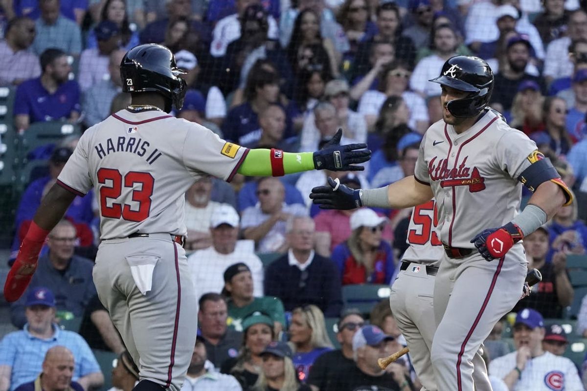 May 22, 2024; Chicago, Illinois, USA; Atlanta Braves outfielder Adam Duvall (14) celebrates his two-run home run with outfielder Michael Harris II (23) against the Chicago Cubs during the third inning at Wrigley Field. Mandatory Credit: David Banks-USA TODAY Sports