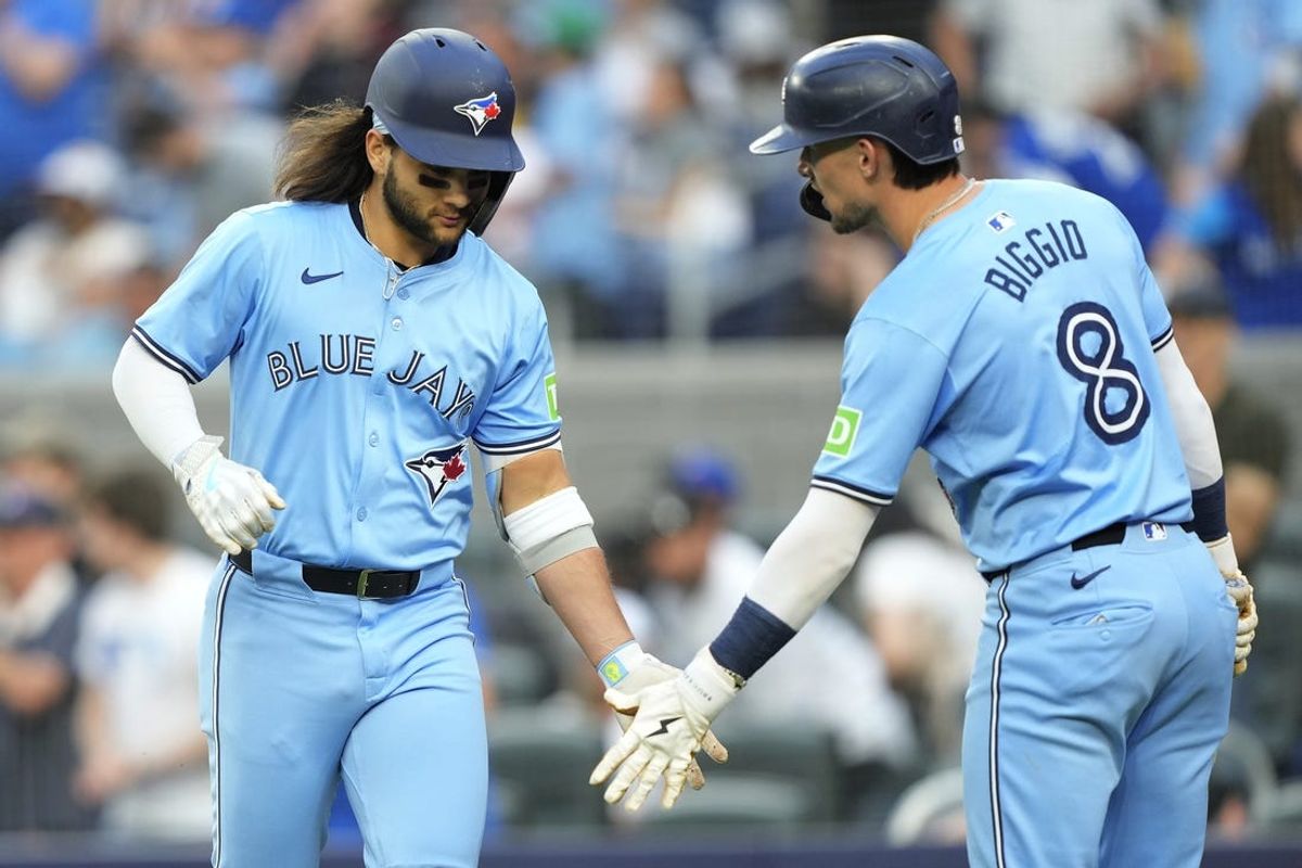 May 22, 2024; Toronto, Ontario, CAN; Toronto Blue Jays right fielder Cavan Biggio (8) congratulates shortstop Bo Bichette (11) after his two-run home run against the Chicago White Sox during the second inning at Rogers Centre. Mandatory Credit: John E. Sokolowski-USA TODAY Sports