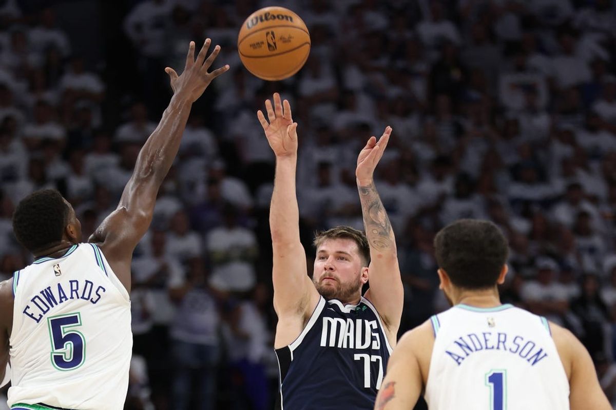 May 22, 2024; Minneapolis, Minnesota, USA; Dallas Mavericks guard Luka Doncic (77) shoots against Minnesota Timberwolves guard Anthony Edwards (5) in the first quarter during game one of the western conference finals for the 2024 NBA playoffs at Target Center. Mandatory Credit: Jesse Johnson-USA TODAY Sports