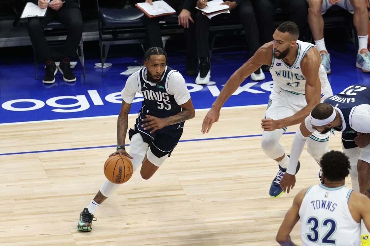 May 22, 2024; Minneapolis, Minnesota, USA; Dallas Mavericks forward Derrick Jones Jr. (55) controls the ball against Minnesota Timberwolves center Rudy Gobert (27) in the third quarter during game one of the western conference finals for the 2024 NBA playoffs at Target Center. Mandatory Credit: Jesse Johnson-USA TODAY Sports