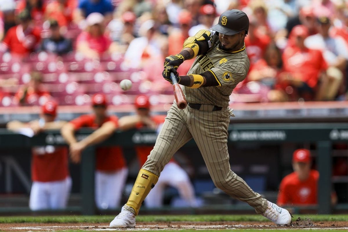 May 23, 2024; Cincinnati, Ohio, USA; San Diego Padres first baseman Luis Arraez (4) hits a single against the Cincinnati Reds in the first inning at Great American Ball Park. Mandatory Credit: Katie Stratman-USA TODAY Sports