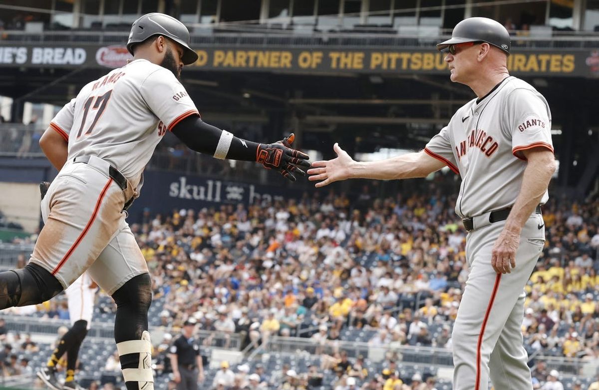 May 23, 2024; Pittsburgh, Pennsylvania, USA; San Francisco Giants third base coach Matt Williams (right) congratulates left fielder Heliot Ramos (17) heading to home plate on a solo home run against the Pittsburgh Pirates during the seventh inning at PNC Park. Mandatory Credit: Charles LeClaire-USA TODAY Sports