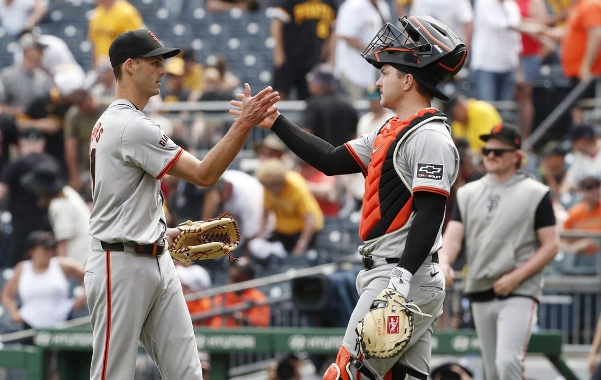 May 23, 2024; Pittsburgh, Pennsylvania, USA; San Francisco Giants relief pitcher Tyler Rogers (71) and catcher Patrick Bailey (right) celebrate after defeating the Pittsburgh Pirates at PNC Park. Mandatory Credit: Charles LeClaire-USA TODAY Sports
