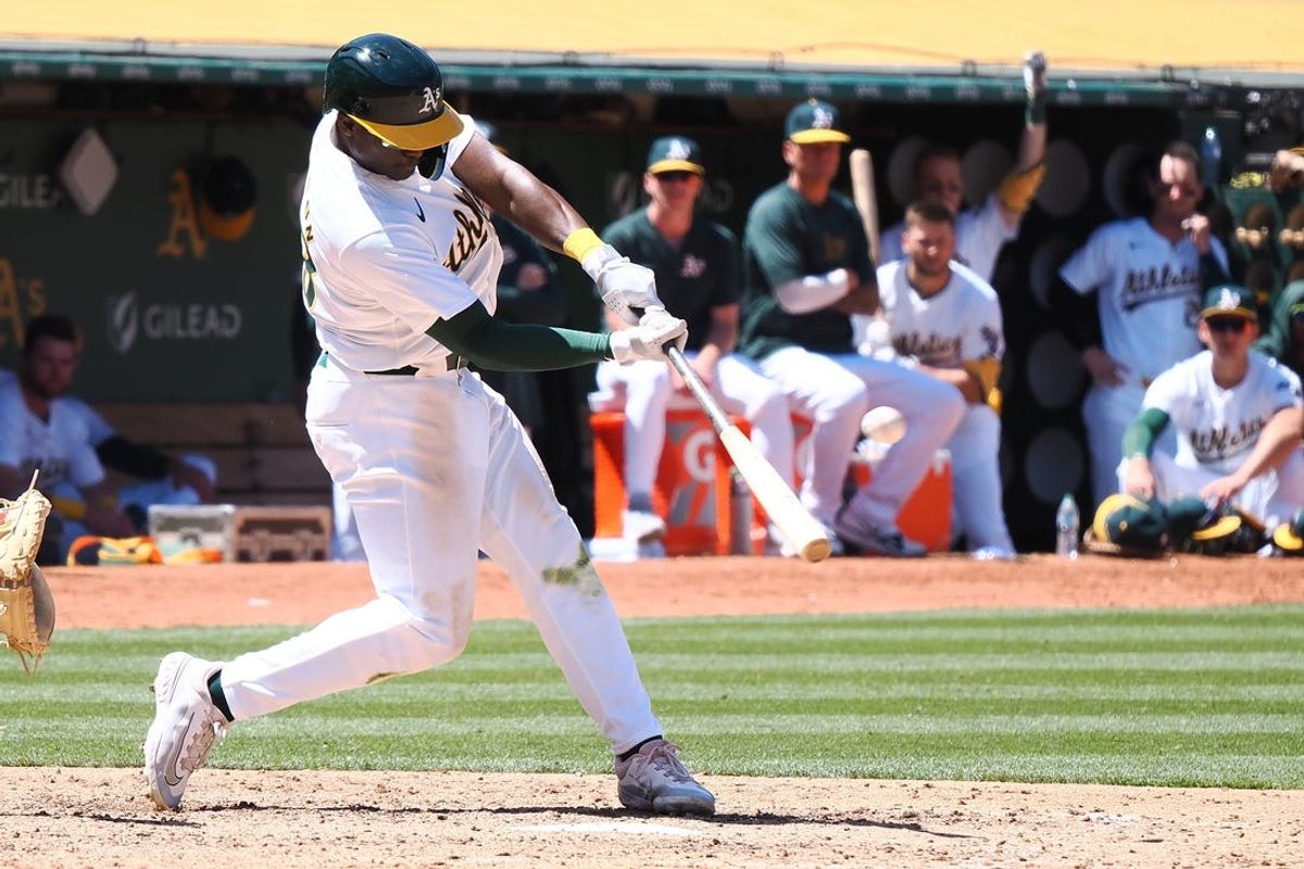May 23, 2024; Oakland, California, USA; Oakland Athletics left fielder Daz Cameron (28) hits a home run against the Colorado Rockies during the ninth inning at Oakland-Alameda County Coliseum. Mandatory Credit: Kelley L Cox-USA TODAY Sports