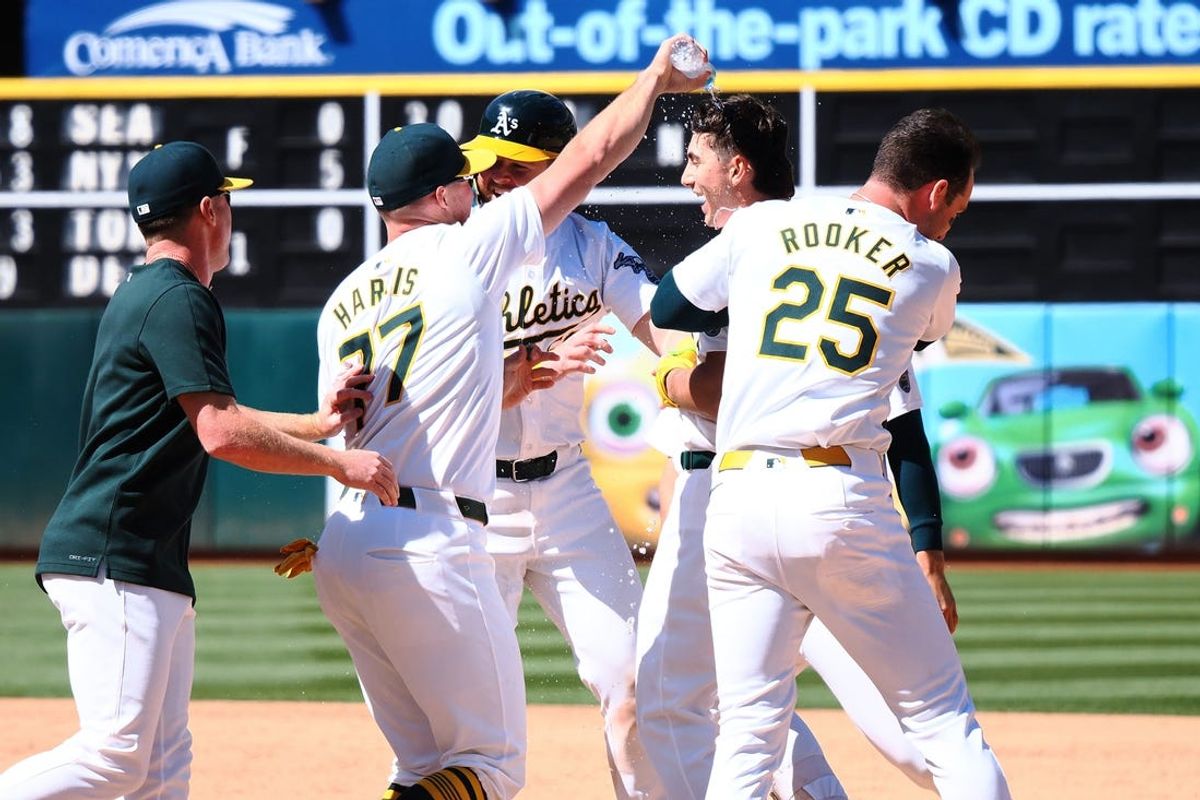 May 23, 2024; Oakland, California, USA; Oakland Athletics pinch hitter Tyler Soderstrom (21) celebrates with teammates after a walk-off win against the Colorado Rockies during the eleventh inning at Oakland-Alameda County Coliseum. Mandatory Credit: Kelley L Cox-USA TODAY Sports