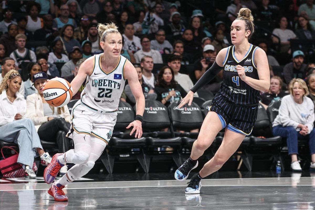 May 23, 2024; Brooklyn, New York, USA;  New York Liberty guard Courtney Vandersloot (22) drives past Chicago Sky guard Marina Mabrey (4) in the first quarter at Barclays Center. Mandatory Credit: Wendell Cruz-USA TODAY Sports