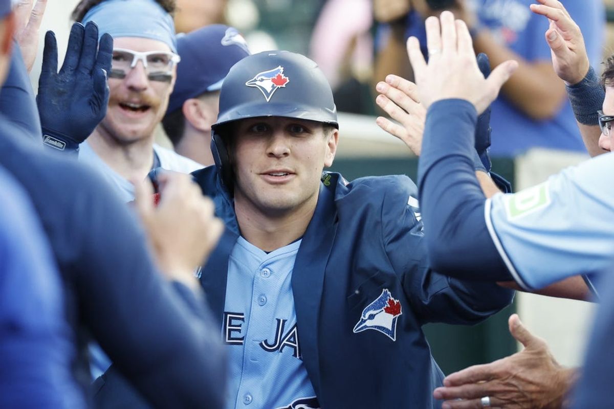 May 23, 2024; Detroit, Michigan, USA;  Toronto Blue Jays left fielder Daulton Varsho (25) is congratulated by teammates after hitting a two-run home run in the seventh inning against the Detroit Tigers at Comerica Park. Mandatory Credit: Rick Osentoski-USA TODAY Sports