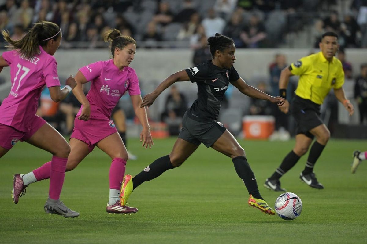 May 23, 2024; Los Angeles, California, USA; Angel City FC defender Jasmyne Spencer (3) plays the ball defended by San Diego Wave FC midfielder Kristen McNabb (14) and forward Maria Sanchez (77) in the first half at BMO Stadium. Mandatory Credit: Jayne Kamin-Oncea-USA TODAY Sports