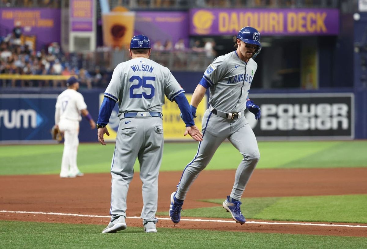 May 24, 2024; St. Petersburg, Florida, USA;  Kansas City Royals shortstop Bobby Witt Jr. (7) is congratulated by third base coach Vance Wilson (25) after he hit a home run against the Tampa Bay Rays during the seventh inning at Tropicana Field. Mandatory Credit: Kim Klement Neitzel-USA TODAY Sports
