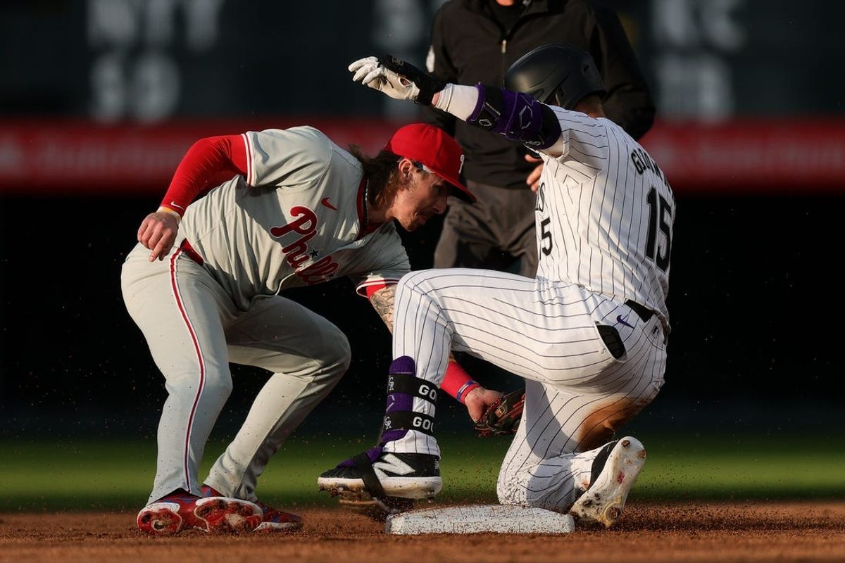 May 24, 2024; Denver, Colorado, USA; Colorado Rockies right fielder Hunter Goodman (15) slides safely into second agains tPhiladelphia Phillies second baseman Bryson Stott (5) on a double in the fifth inning at Coors Field. Mandatory Credit: Isaiah J. Downing-USA TODAY Sports