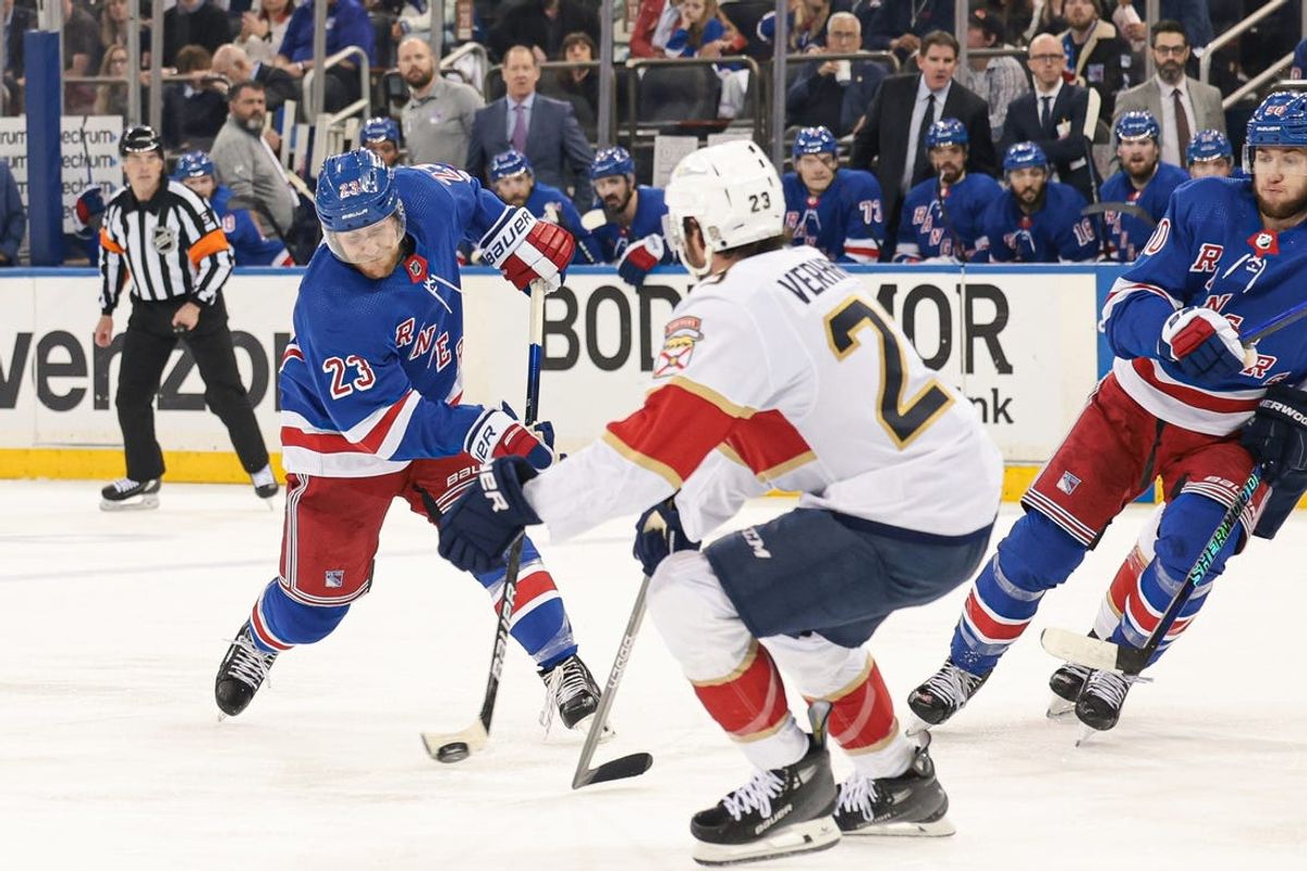 May 24, 2024; New York, New York, USA; New York Rangers defenseman Adam Fox (23) shoots the puck as Florida Panthers center Carter Verhaeghe (23) defends during the second period in game two of the Eastern Conference Final of the 2024 Stanley Cup Playoffs at Madison Square Garden. Mandatory Credit: Vincent Carchietta-USA TODAY Sports
