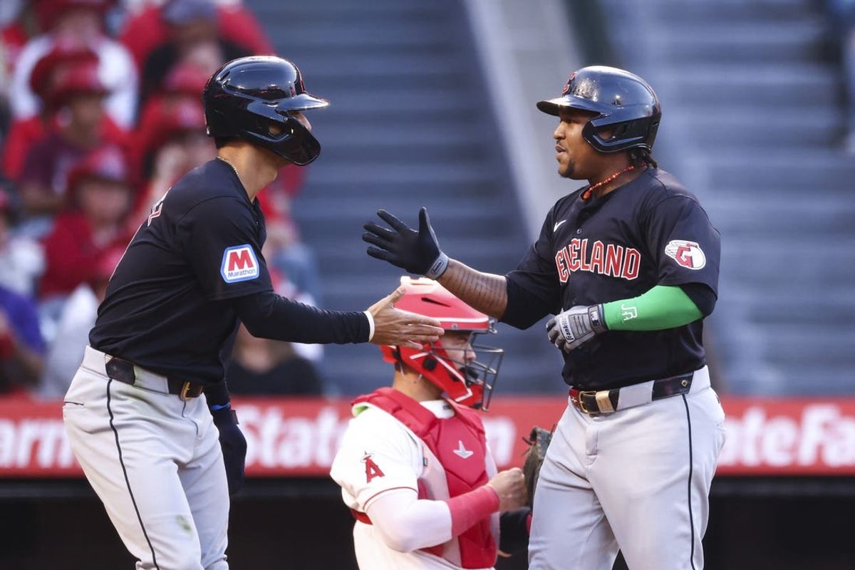 May 24, 2024; Anaheim, California, USA; Cleveland Guardians third base José Ramírez (11) celebrates with second base Andrés Giménez (0) after Ramírez hits a home run against the Los Angeles Angels during the third inning of a game at Angel Stadium. Mandatory Credit: Jessica Alcheh-USA TODAY Sports