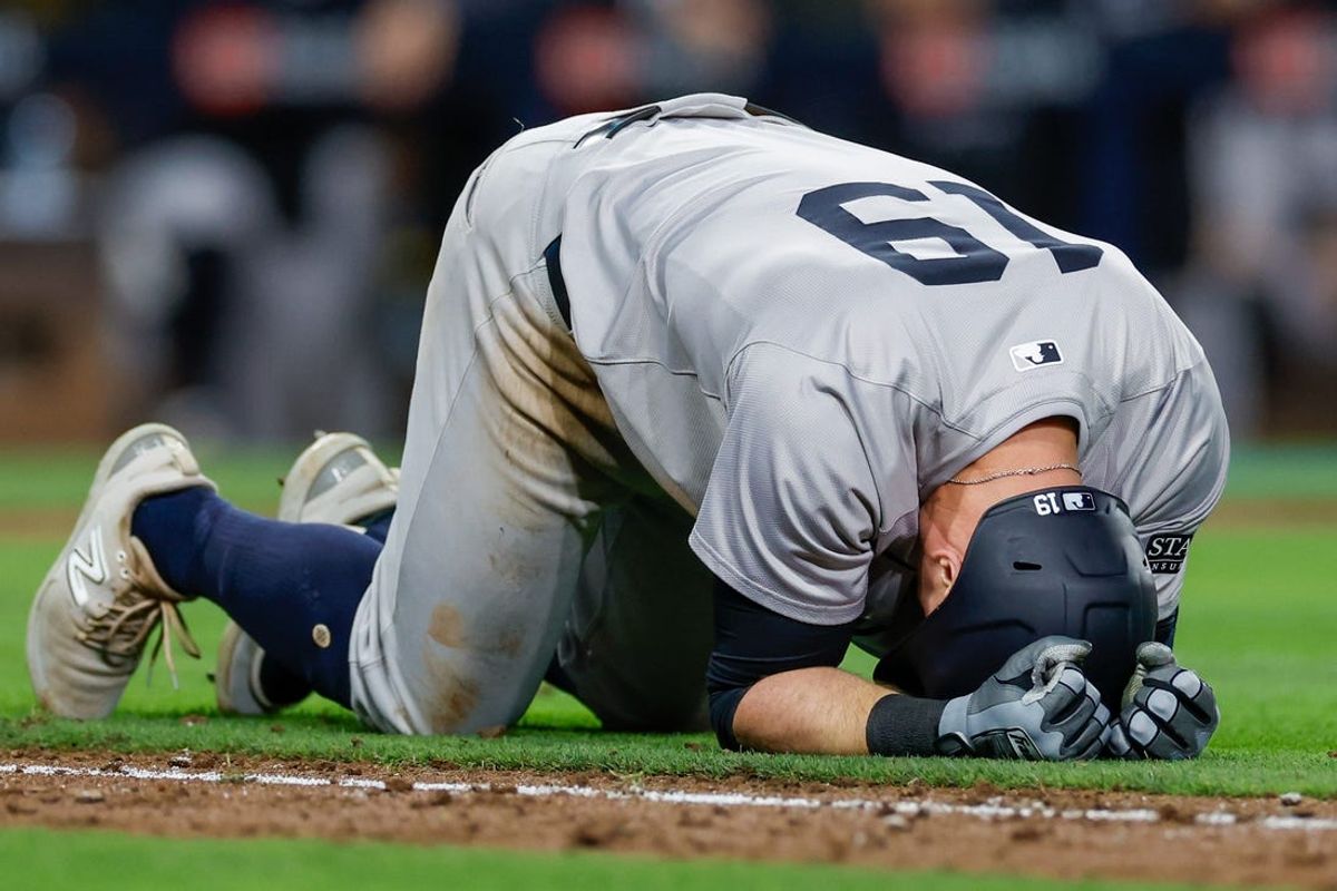 May 24, 2024; San Diego, California, USA; New York Yankees third baseman Jon Berti (19) collapses while running down to first base after sustaining an injury in the ninth inning against the San Diego Padres at Petco Park. Mandatory Credit: David Frerker-USA TODAY Sports