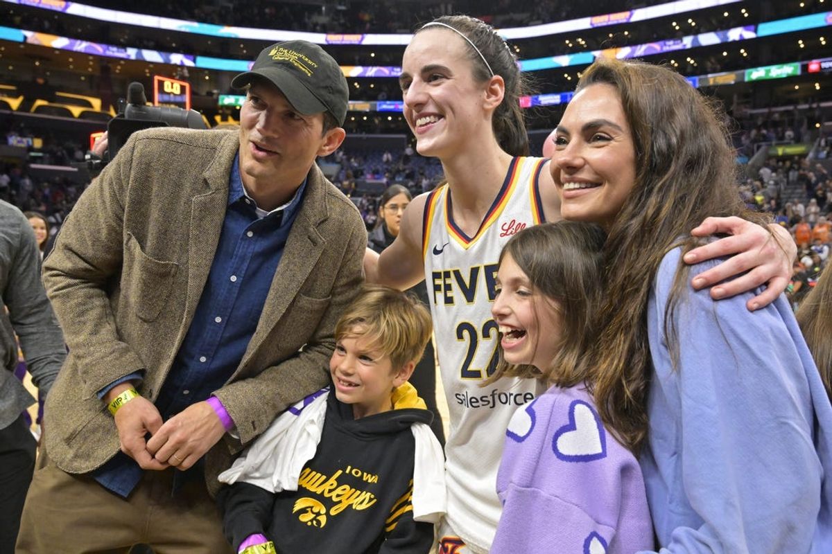May 24, 2024; Los Angeles, California, USA;  Indiana Fever guard Caitlin Clark (22) takes a photo with actors Ashton Kutcher, Mila Kunis and their daughter Wyatt and son Dimitri following the game against the Los Angeles Sparks at Crypto.com Arena. Mandatory Credit: Jayne Kamin-Oncea-USA TODAY Sports